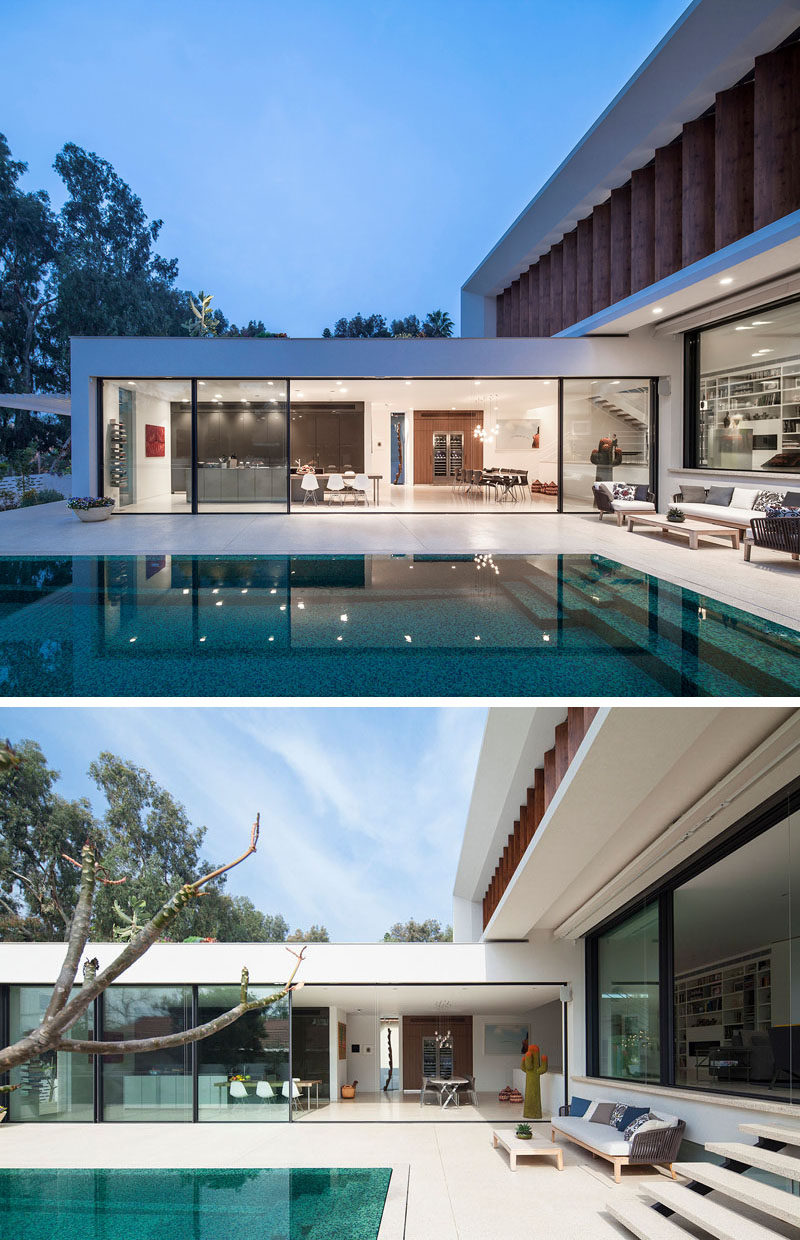 A small outdoor living area is located at one end of this swimming pool, and sits next to stairs that lead to the inside living room.