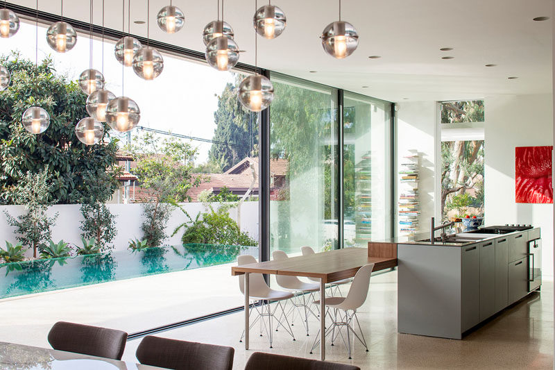 Large sliding glass doors next to the open plan kitchen and dining area add to the indoor/outdoor living aspect of this home.