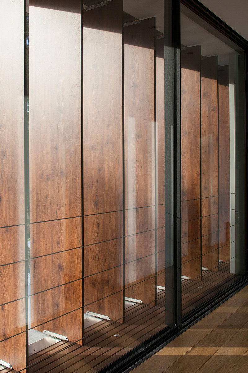 Teak louver panels have been used on the upper floor of this home, providing privacy and shade when needed.