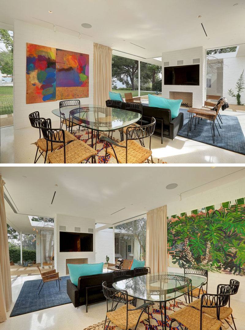 Between the living room and the kitchen of this small home is the dining room. Art has been positioned on both sides of the dining room, helping to anchor the area in the open floor plan.