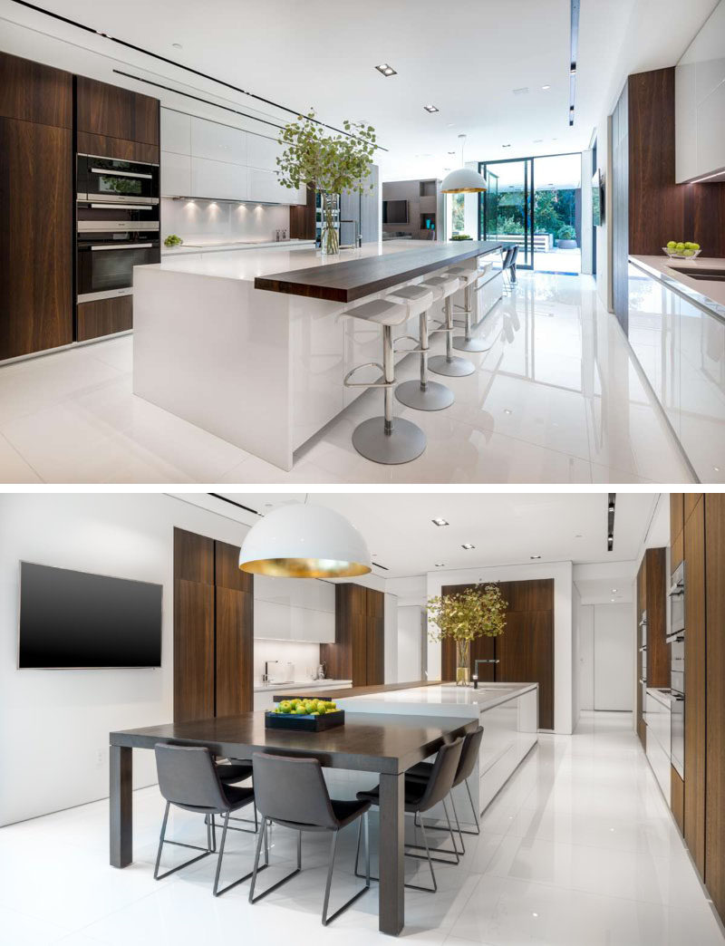 This kitchen has a wooden countertop that matches the cabinetry and provides seating for four, while at the other end of the kitchen there's a more casual dining table.