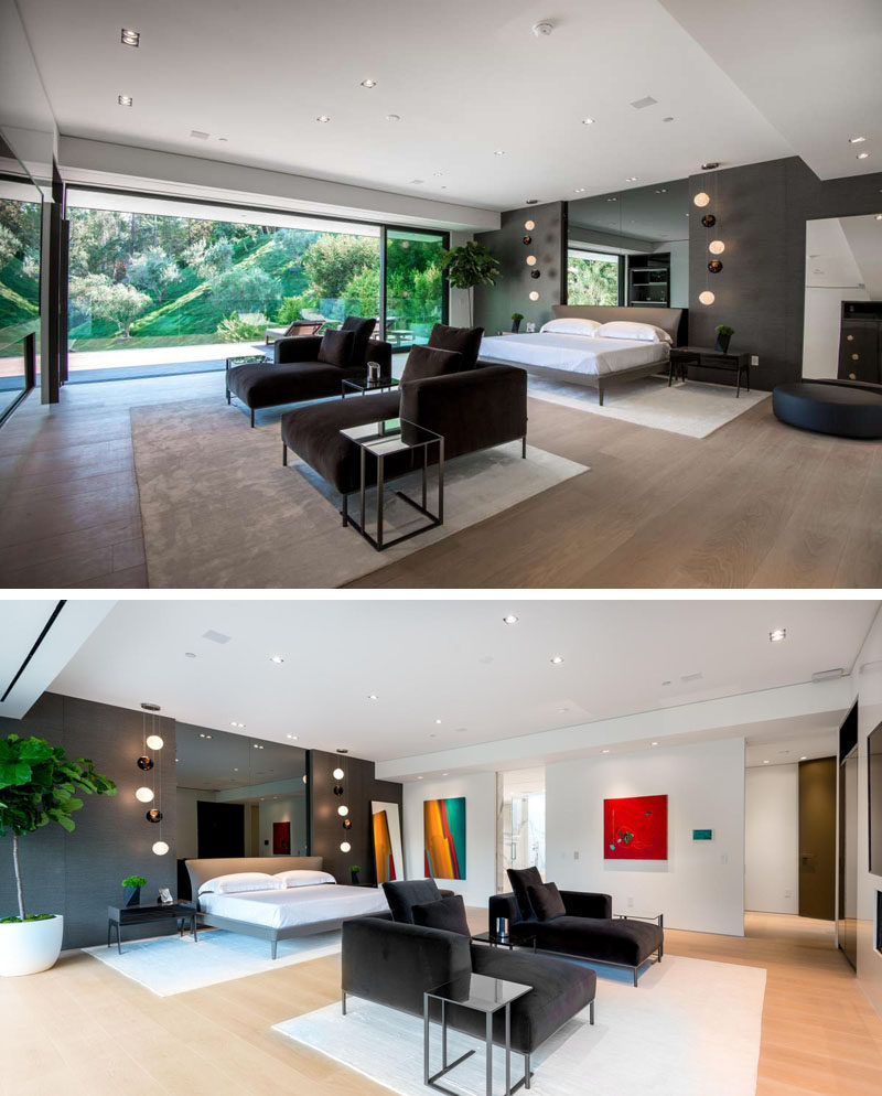 This master bedroom with its own sitting area and fireplace, and opens up to a balcony overlooking the backyard. Rugs have been used to separate the space and define the different areas of the bedroom.