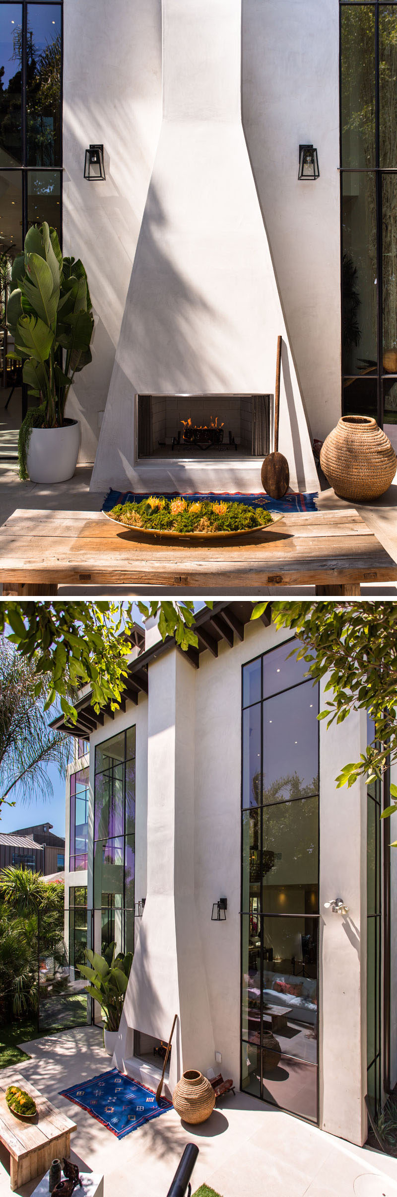 This home has a dramatic white outdoor fireplace with a chimney that runs the height of the home.