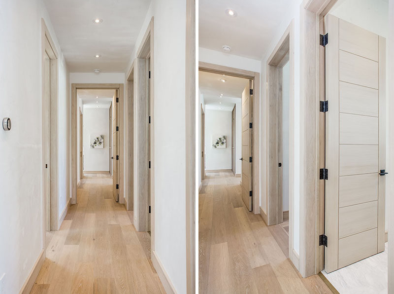 The hallways of this home have been kept light with the use of a light wood floor, doors and trim. The only dark touches are the door hinges and handles.