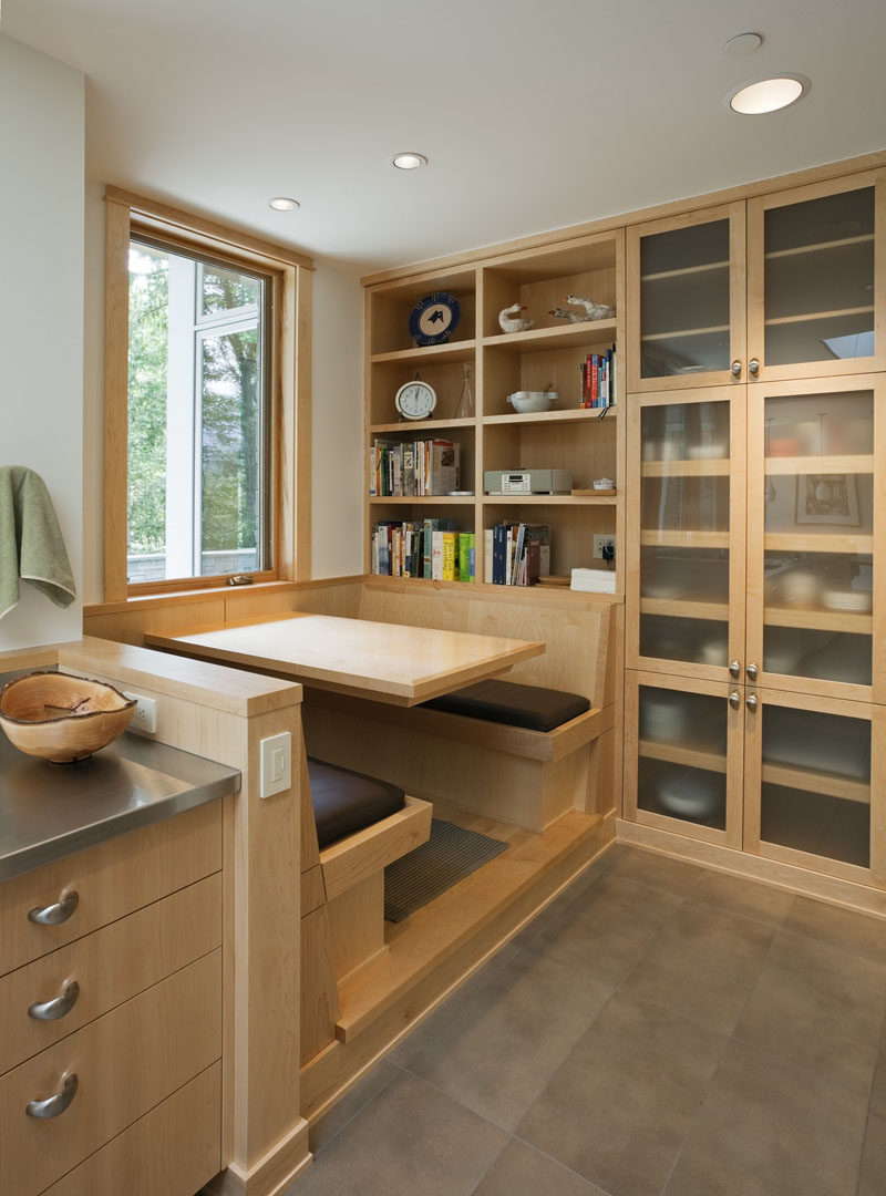 Dining Room Idea - Create A Built-In Dining Nook // Light wood and a large window help make this small dining nook a bright cozy spot. A wall of shelves and cabinets keeps everything at arms length. #DiningNook #BuiltInDiningNook #BanquetteSeating #DiningRoom