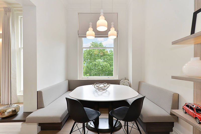 Dining Room Idea - Create A Built-In Dining Nook // Light fabric, white walls, and high ceilings make this large dining nook a bright and airy space, while additional chairs make sure there is room for everyone around the table. #DiningNook #BuiltInDiningNook #BanquetteSeating #DiningRoom