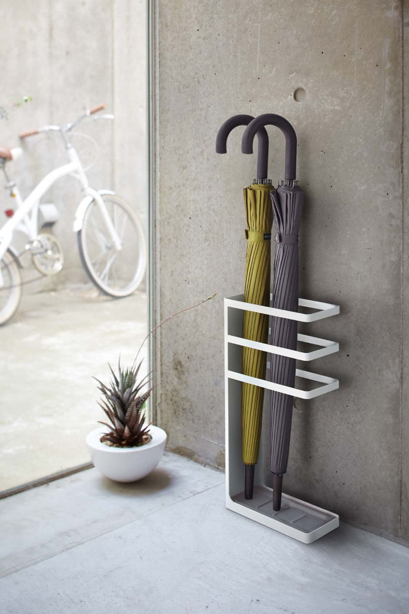 Interior Design Idea - What To Include When Creating The Ultimate Entryway // Umbrella Stand -- Rather than hanging your umbrella on a hook on the wall, where the water trickles down the wall, or just on the floor where you will have a puddle of water - add a simple umbrella stand to your entryway.