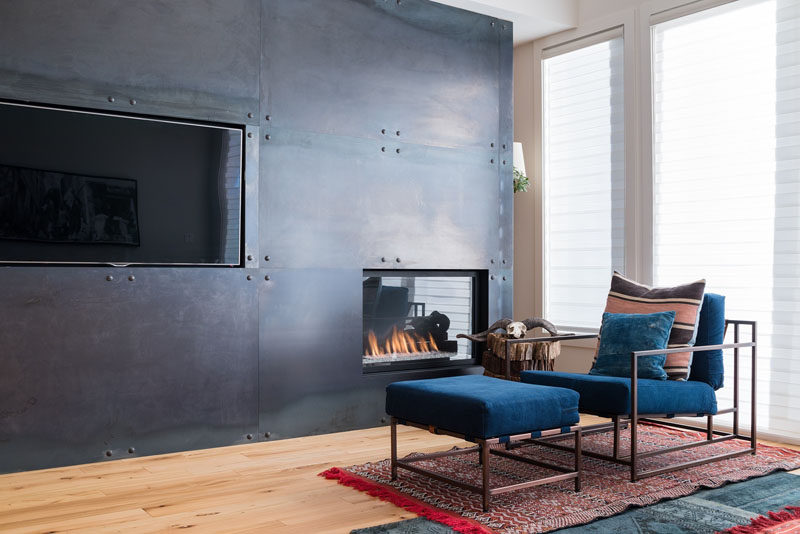 Fireplace Design Idea - 6 Different Materials To Use For A Fireplace Surround // A black steel fireplace surround gives a modern, industrial feel to a room. #FireplaceSurround #FireplaceIdeas #SteelFireplaceSurround