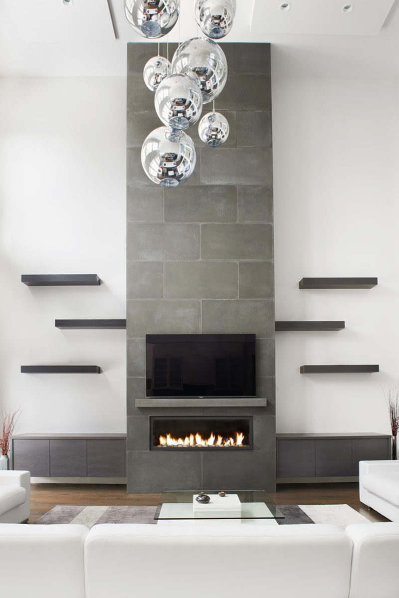 Fireplace Design Idea - 6 Different Materials To Use For A Fireplace Surround // This concrete fireplace surround draws your eye and provides a place to mount your tv. #FireplaceSurround #FireplaceIdeas #ConcreteFireplaceSurround