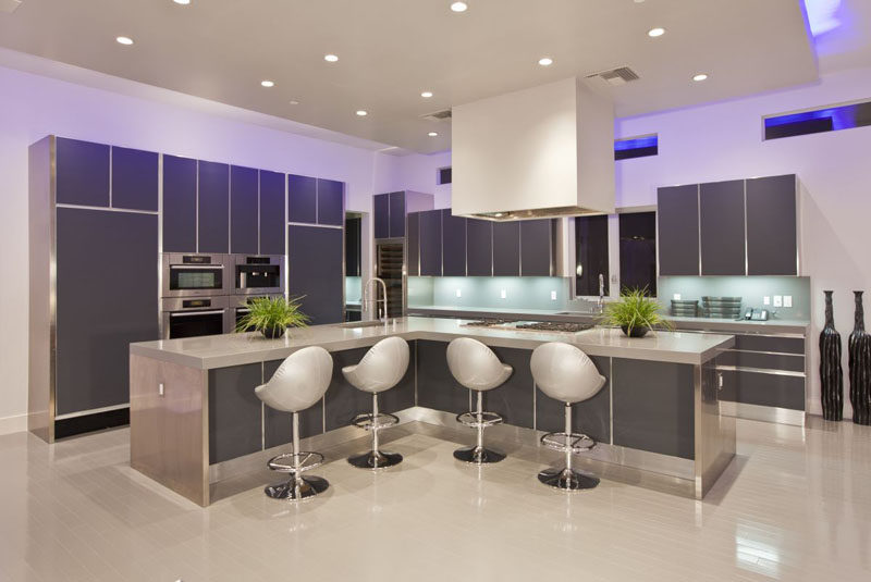 12 Examples Of Sophisticated Gray Kitchen Cabinets // Futuristic chairs and lighting as well as the dark gray cabinetry make this kitchen feel super modern.