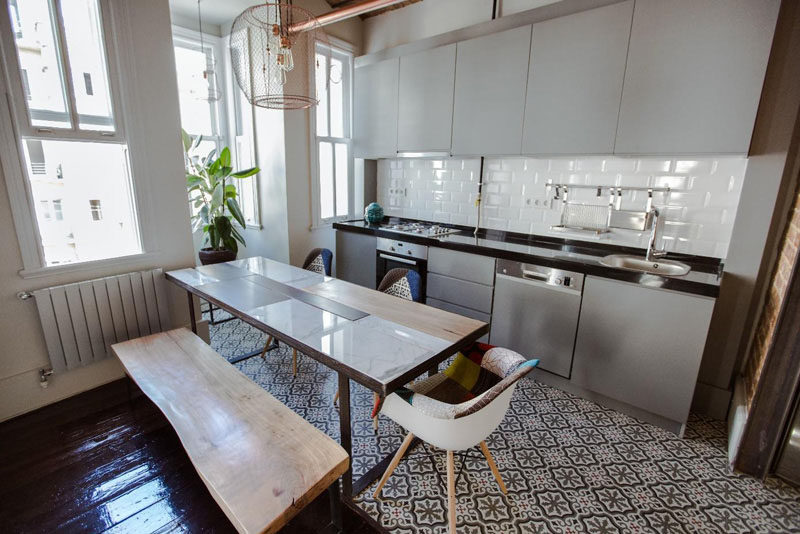 12 Examples Of Sophisticated Gray Kitchen Cabinets // The light gray cabinetry in this kitchen compliments the tones in the tile, and makes the old apartment feel inviting and new.