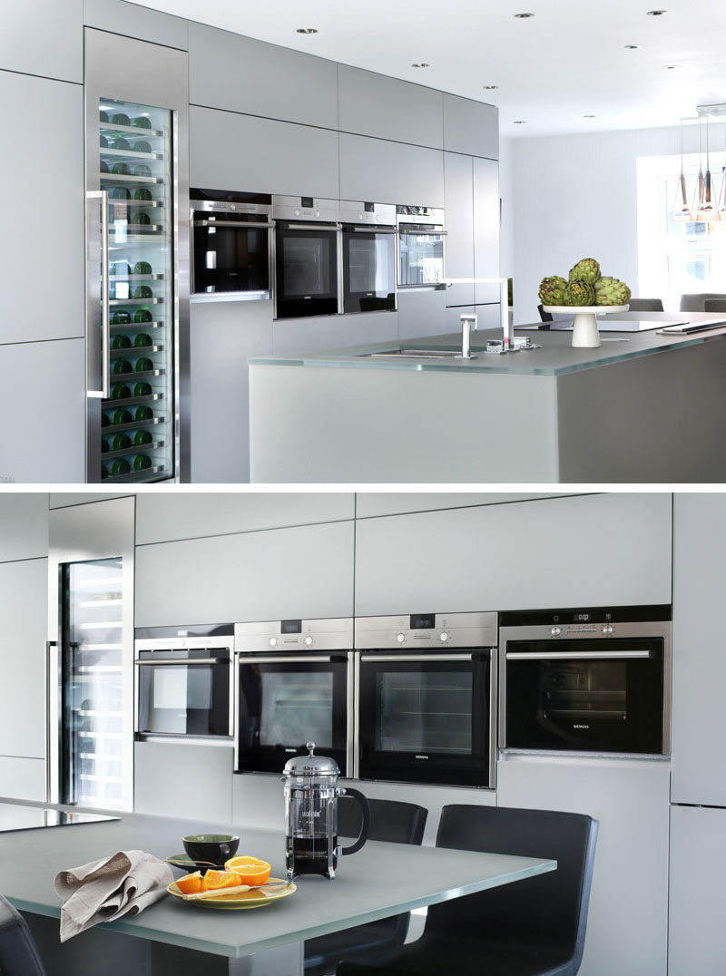 12 Examples Of Sophisticated Gray Kitchen Cabinets // A wall of light gray cabinets match the island in this kitchen.