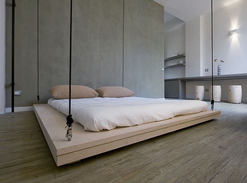 In this small apartment, the bed can be hoisted up to the ceiling to make way for a living area.