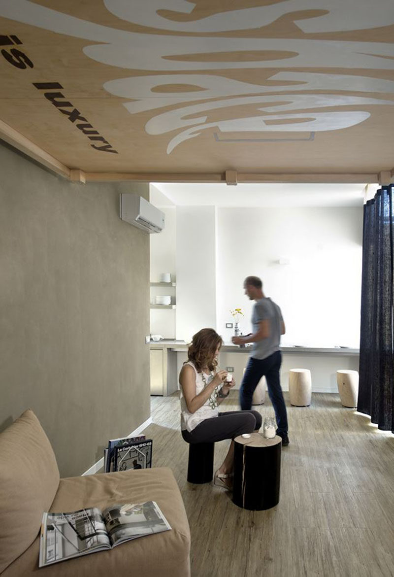 In this small apartment, the bed can be hoisted up to the ceiling to make way for a living area.