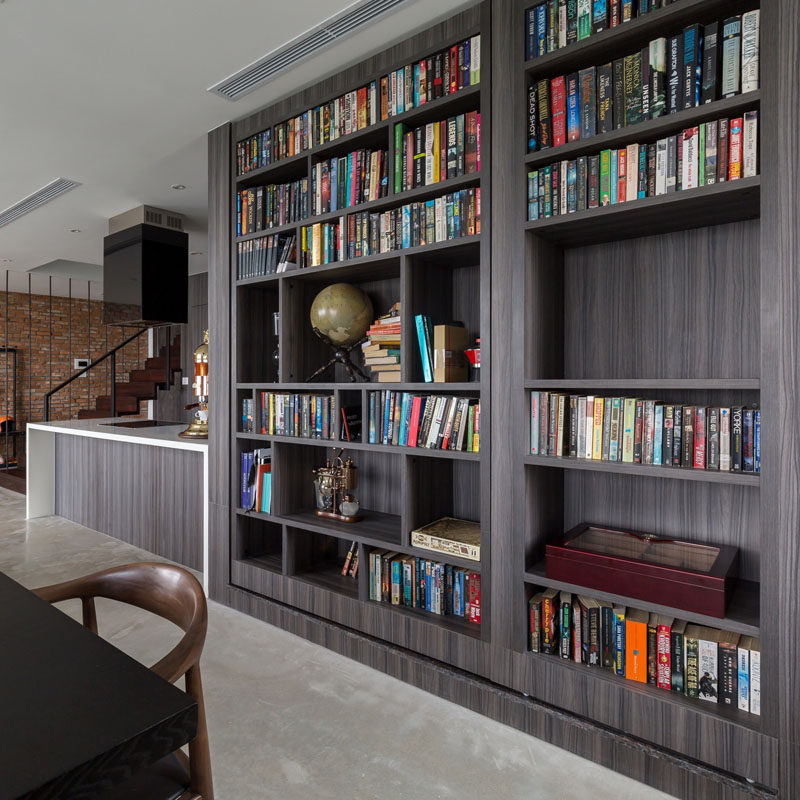 A secret guest bedroom/home office is hidden behind a bookshelf in this home.