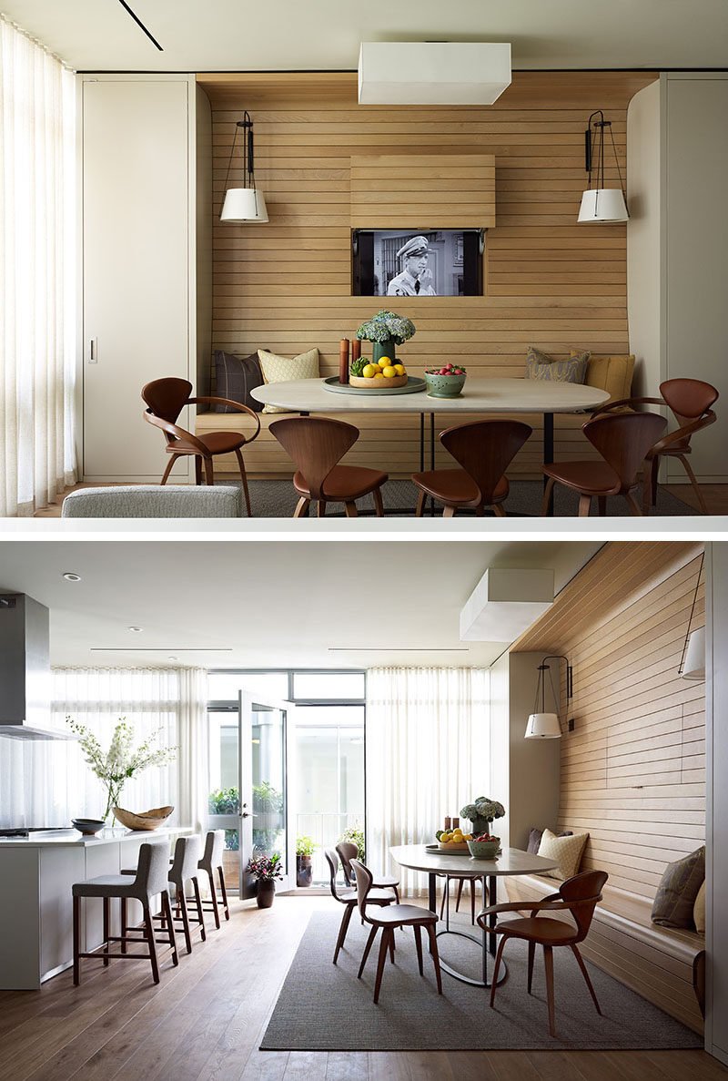 In this apartment, the television was placed behind a panel within the walnut wall, allowing it to be visible for when you want to watch tv, but at the same time, can be completely hidden away without the use of a bulky cabinet.