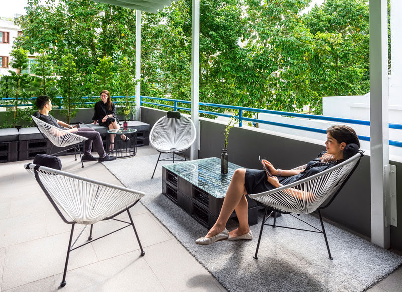 The private terrace of a hostel in Singapore has casual, relaxed seating.