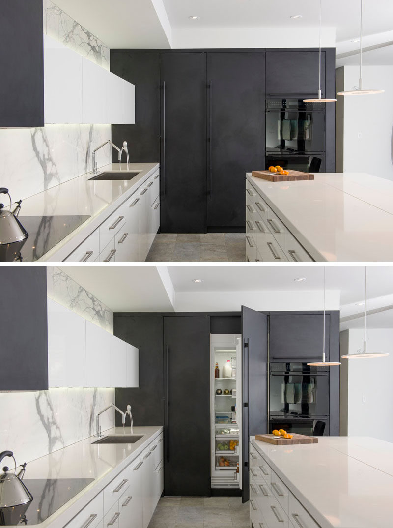 Kitchen Design Idea - 10 Inspirational Examples Of Kitchens With Integrated Fridges // Dark cabinetry seamlessly hides the fridge in this modern two-tone kitchen.