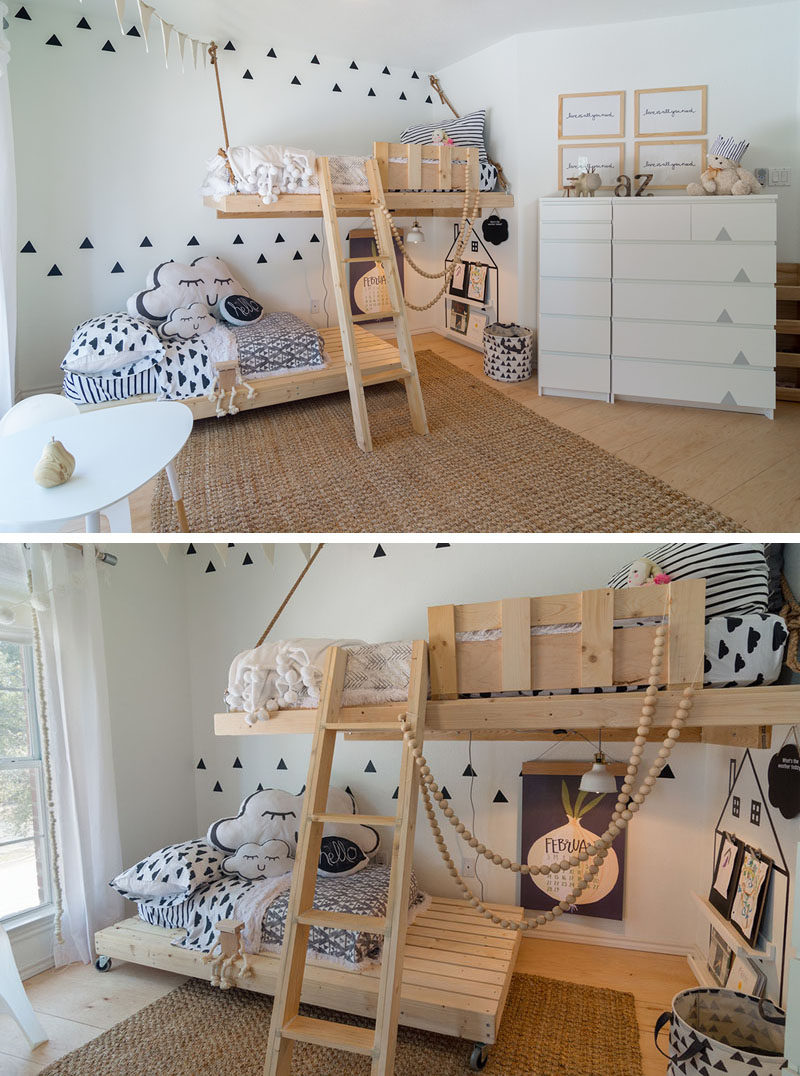 This gender neutral kids room features bright white walls, Scandinavian inspired decor and custom made wooden beds. The bottom bed even has wheels on it so that it can be moved around when needed.