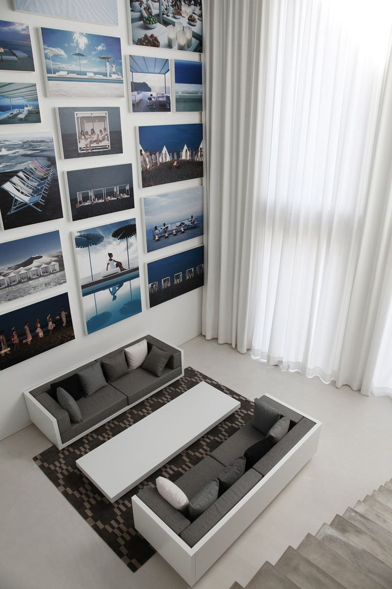 15 Living Room Layouts From Above // White couches with varying tones of grey cushions make a modern seating area in this apartment.