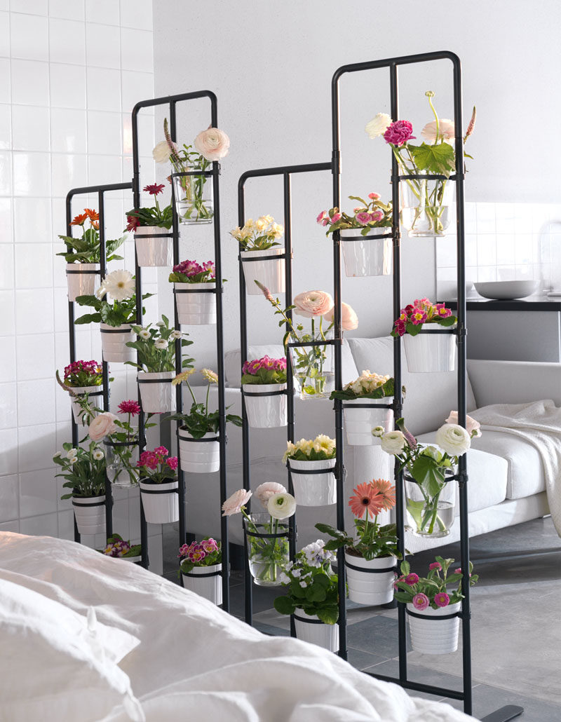 Room Divider Ideas - 10 Examples Of Multi-Functional Room Dividers // A divider filled with flowers and plants is a great way to create separation between spaces and brightens up the whole area.