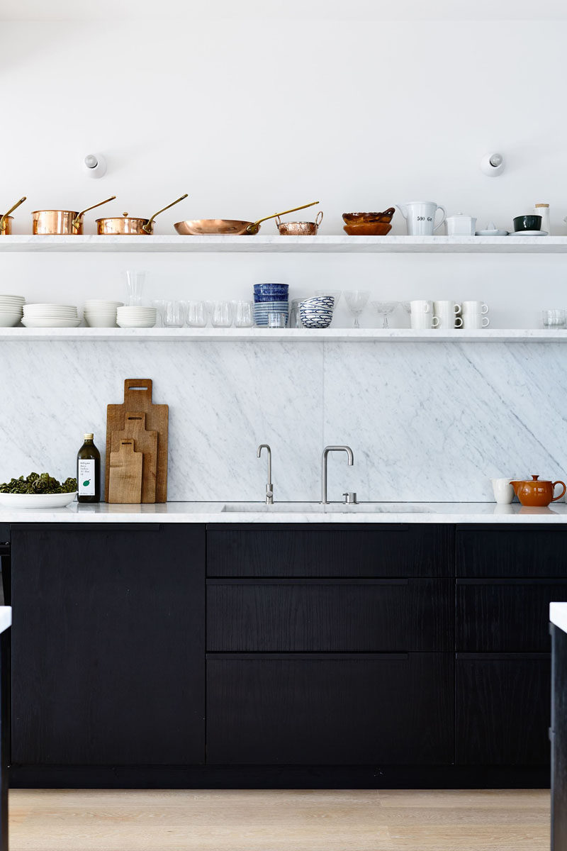 Kitchen Design Idea - Open Shelving (19 Photos) // These long shelves in the same material as the backsplash, are positioned above the sink and counter to provide a convenient spot for storing pots, pans, plates, and mugs.