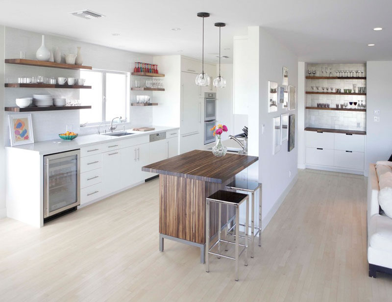 Kitchen Design Idea - Open Shelving (19 Photos) // Dark wood shelving in the kitchen keeps it feeling bright open and matches the open shelving in the bar area just off the kitchen.