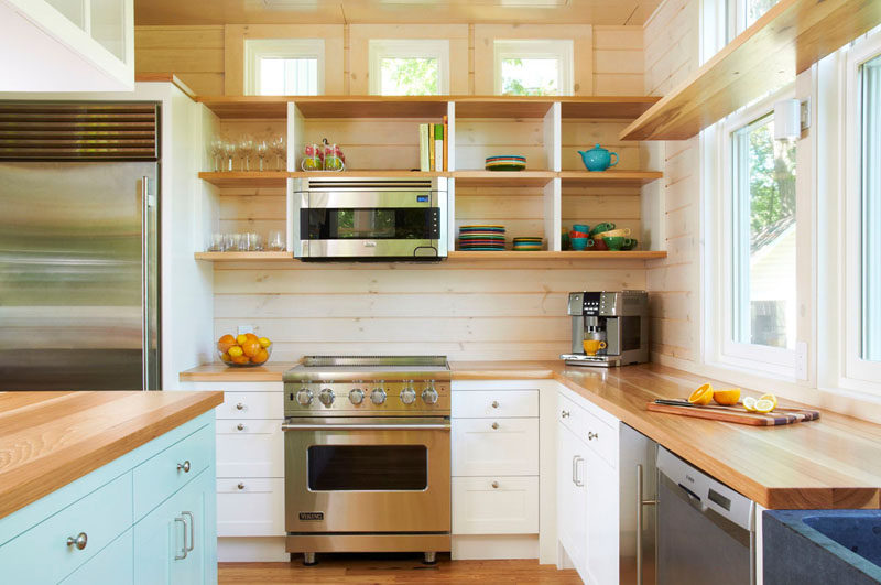 Kitchen Design Idea - Open Shelving (19 Photos) // These wooden shelves are deep and divided, but lack cupboard doors which makes the fun colored plates and mugs act as kitchen decor.