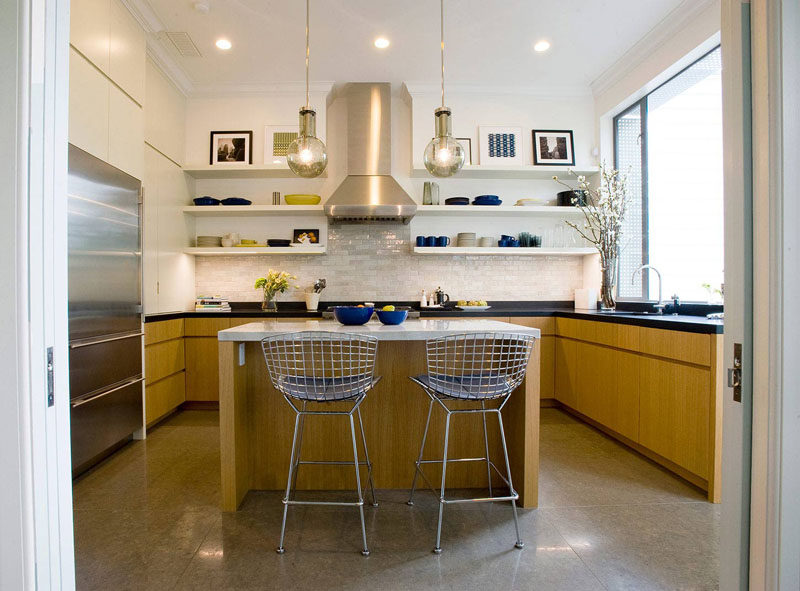 Kitchen Design Idea - Open Shelving (19 Photos) // The open shelves in this kitchen are used to display the daily plates, mugs, and serve ware, with the top shelves used as a place to display favorite pieces of art.