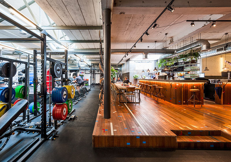 Room Divider Idea - The designers of this gym in Amsterdam made a room divider out of wooden gymnastic rings and straps, to separate the gym area from the bar/food area.