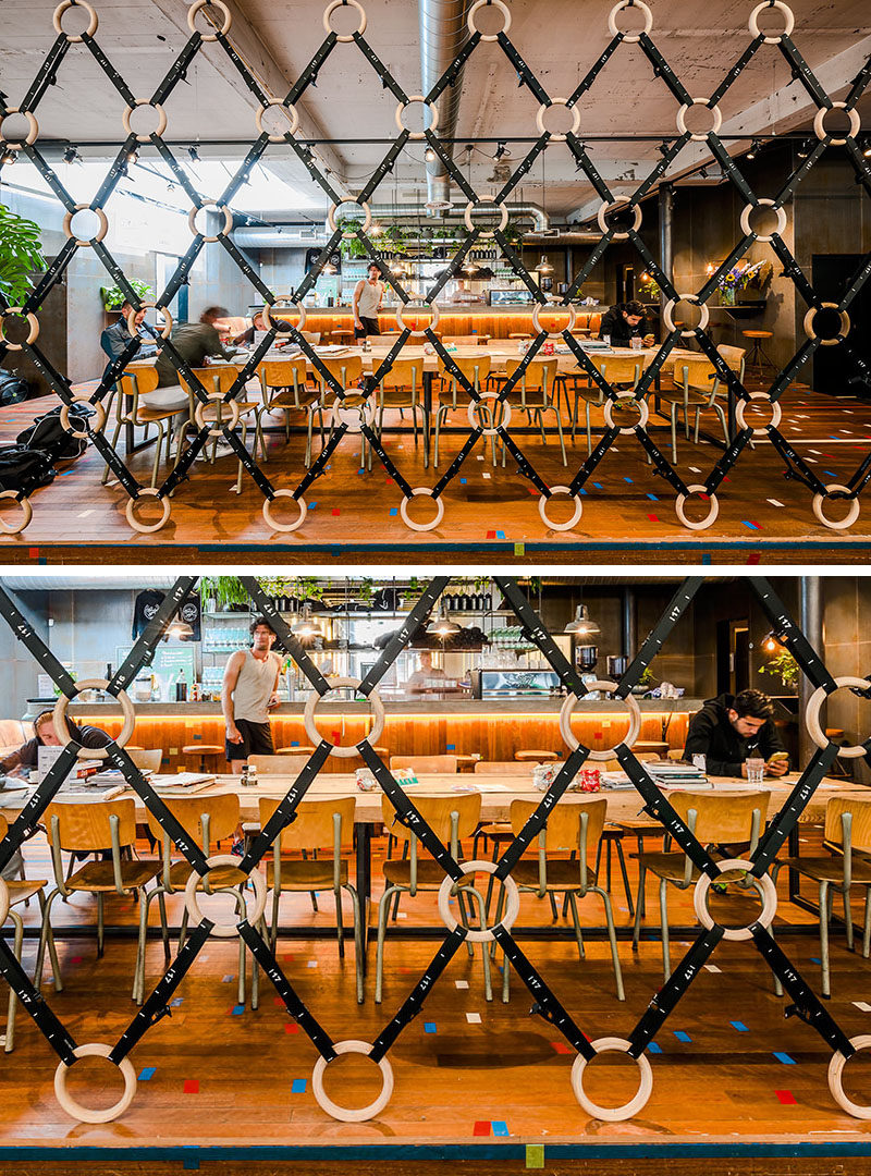 Room Divider Idea - The designers of this gym in Amsterdam made a room divider out of wooden gymnastic rings and straps, to separate the gym area from the bar/food area.