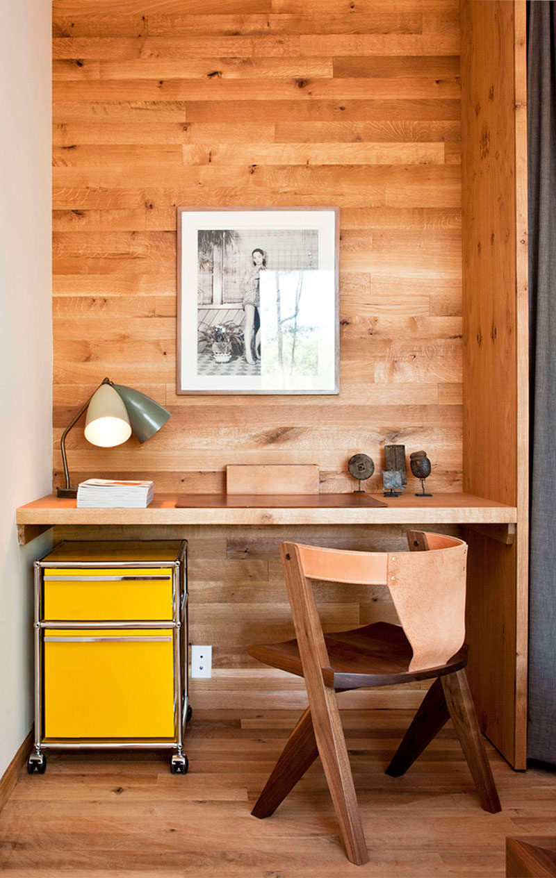 10 Small Home Office Ideas - Wood panels lining the wall of this alcove designate the office space, and the mini yellow filing cabinet adds a fun pop of color, livening up the corner. #HomeOffice #SmallHomeOffice #SmallDesk #InteriorDesign