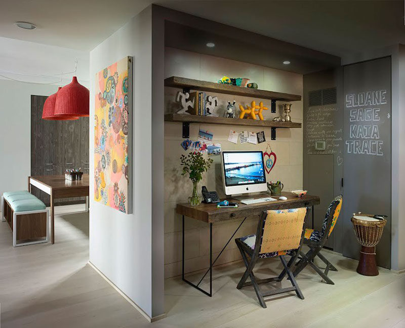 10 Small Home Office Ideas - Tucked into the wall just beside the kitchen sits this family home office. Two shelves and a matching desk provide lots of storage space, and a chalkboard wall makes for a fun place to leave messages for the rest of the family. #HomeOffice #SmallHomeOffice #SmallDesk #InteriorDesign