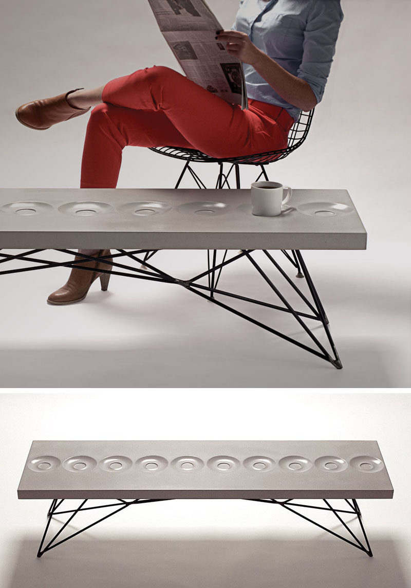 10 Examples Of Concrete and Steel Tables To Add To Your Industrial Interior // This concrete and steel coffee table has saucers built right into the surface to give you a convenient place to sit your coffee while you flip the page of your morning paper.