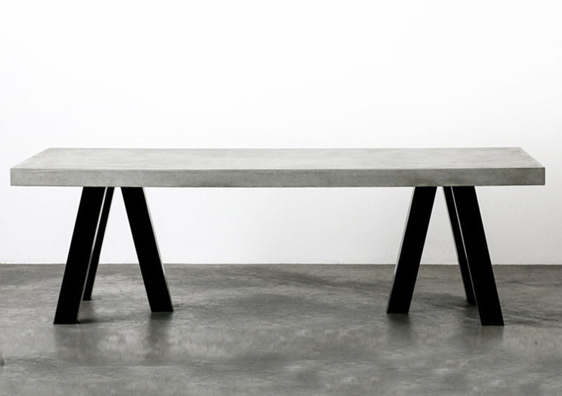 10 Examples Of Concrete and Steel Tables To Add To Your Industrial Interior // Black chunky steel legs and a thick layer of concrete on top make this dining table a solid statement piece.