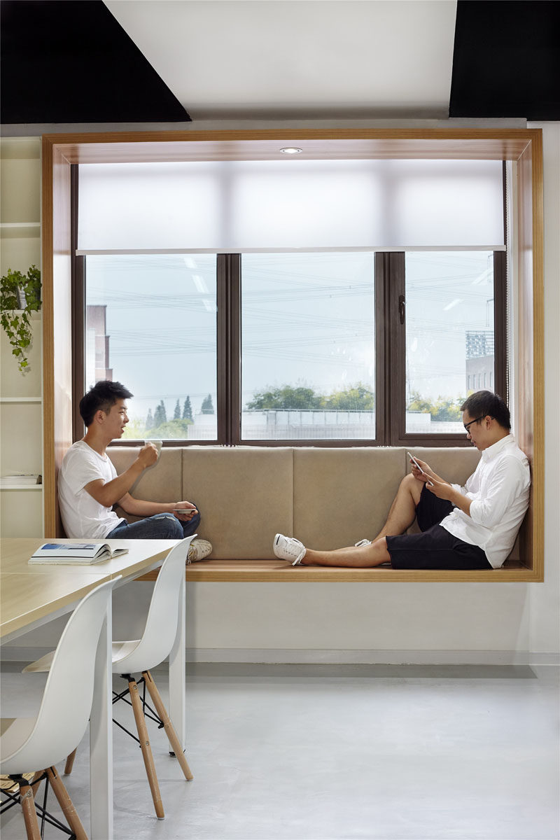 Modern Window Seat Idea - Add a suspended wood surround to standard windows to create an activated space. #ModernWindowSeat #WoodLinedWindowSeat #WorkplaceDesign #OfficeDesign