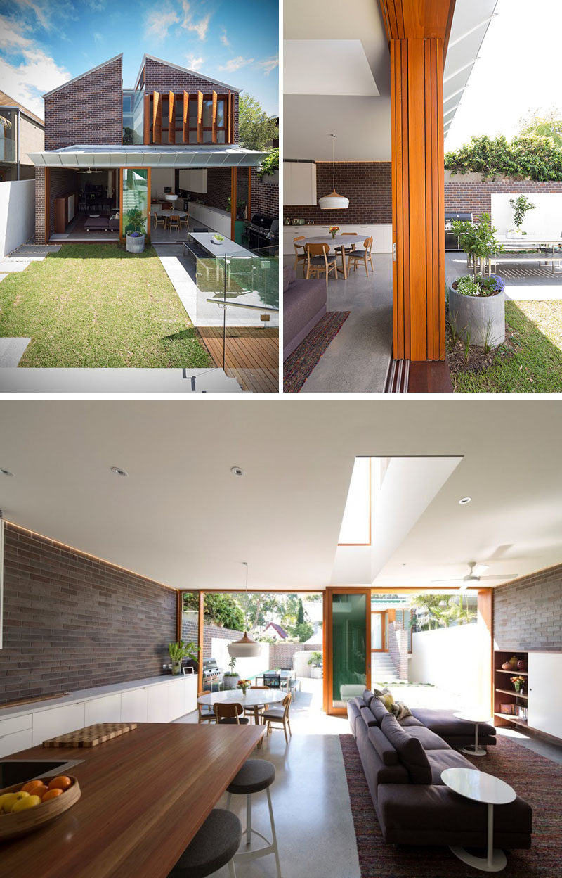 23 Awesome Australian Homes That Perfect Indoor / Outdoor Living // Large doors open up both sides of this home and connect it to the backyard. One side leads out onto the grassy part of the yard while other leads onto a paved dining area with a long table and large BBQ.