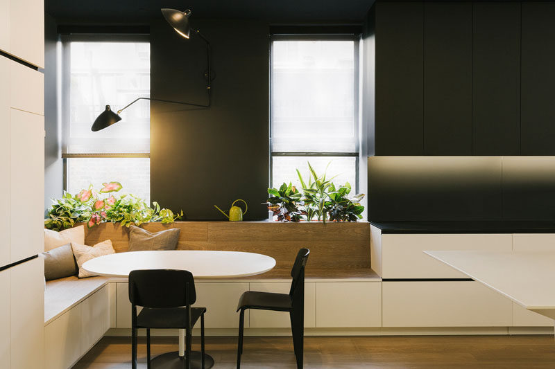 Dining Room Design Ideas - Use Built-In Banquette Seating To Save Space // A built-in dining area, with storage underneath and a place for plants at the top, wraps around the corner of this kitchen.