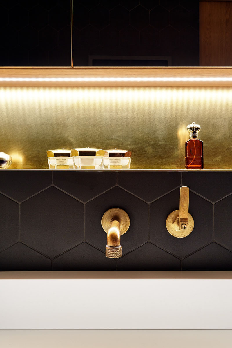 Bathroom Design Idea - Often black in bathrooms can make them feel dark and closed in, but in this Prague apartment architect Lenka Míková, combined black with brass, white and wood to give it a contemporary, luxurious feeling, perfect for a bathroom.