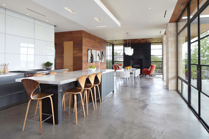 23 Pictures That Show How Concrete Floors Have been Used Throughout Homes // Polished concrete floors in the kitchen and dining area are a great idea because they're easy to clean and extremely durable, just try not to drop anything breakable.