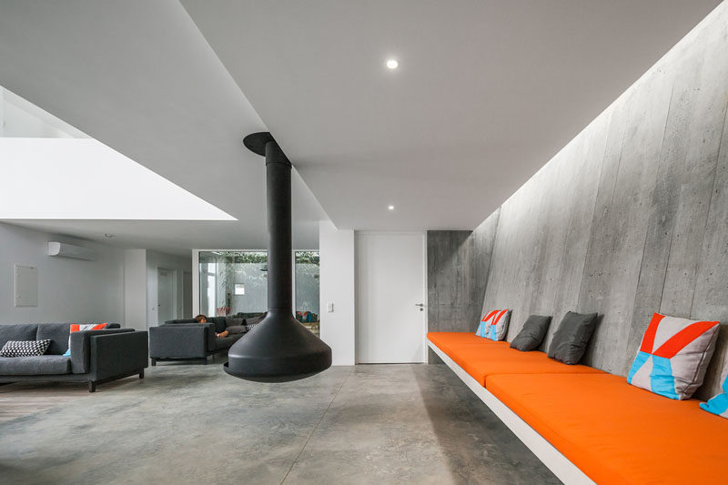 23 Pictures That Show How Concrete Floors Have been Used Throughout Homes // Concrete in the living room may sound cold and uninviting but if it's layered with blankets, pillows, and comfy cushions, the opposite ends up being true.