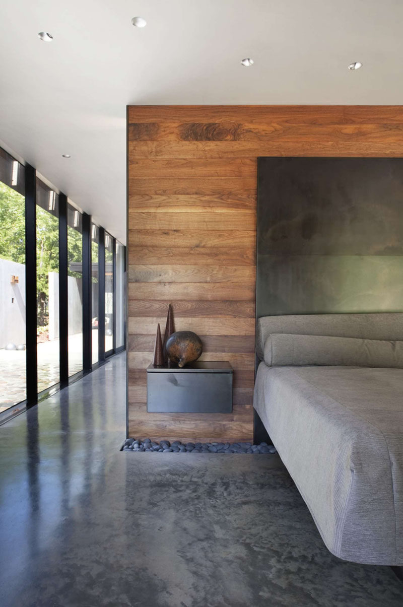 23 Pictures That Show How Concrete Floors Have been Used Throughout Homes // Polished concrete floors in the bedroom create a clean, industrial feel that gets softened and warmed with the addition of bedroom textiles like duvets, pillows, rugs, and drapery. 