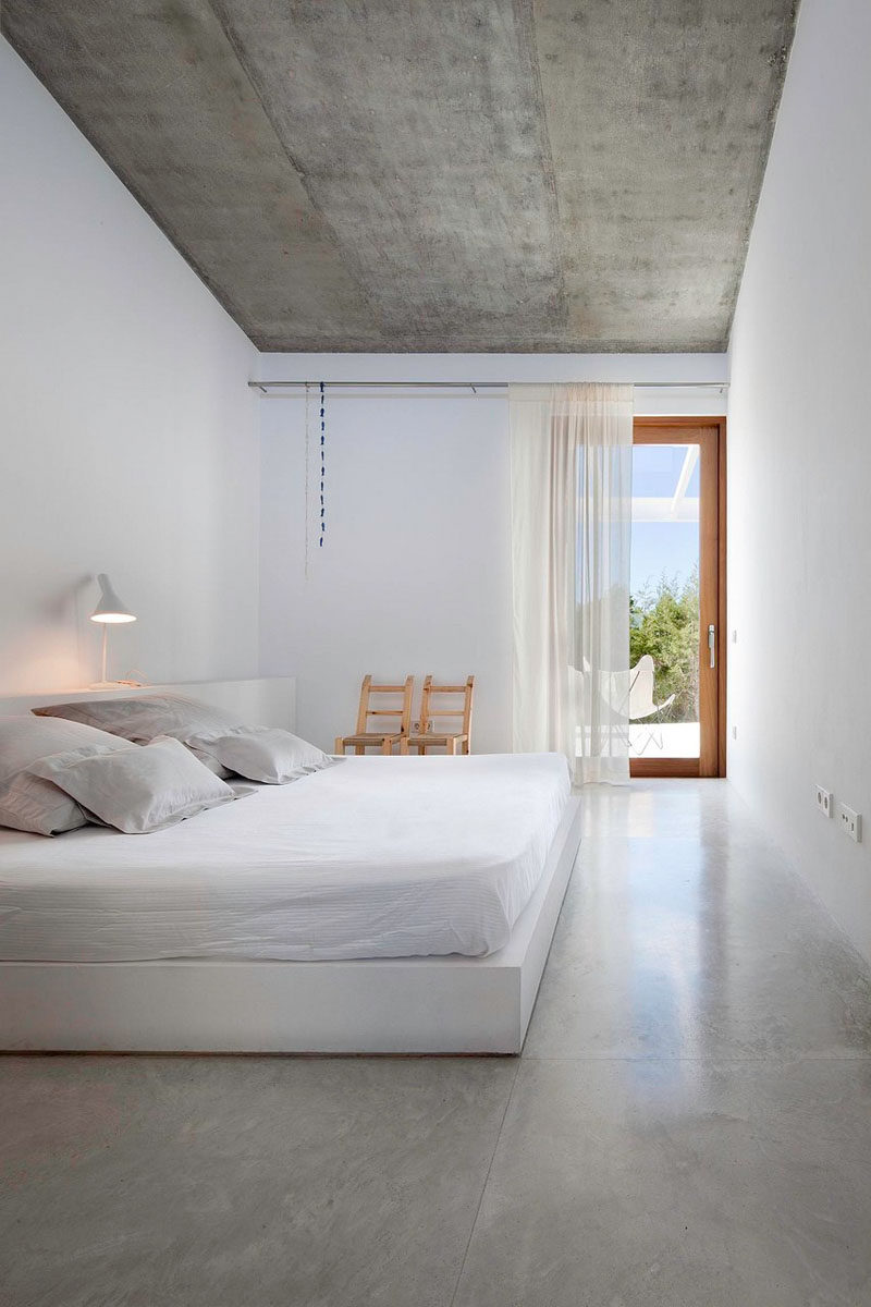 23 Pictures That Show How Concrete Floors Have been Used Throughout Homes // Polished concrete floors in the bedroom create a clean, industrial feel that gets softened and warmed with the addition of bedroom textiles like duvets, pillows, rugs, and drapery. 