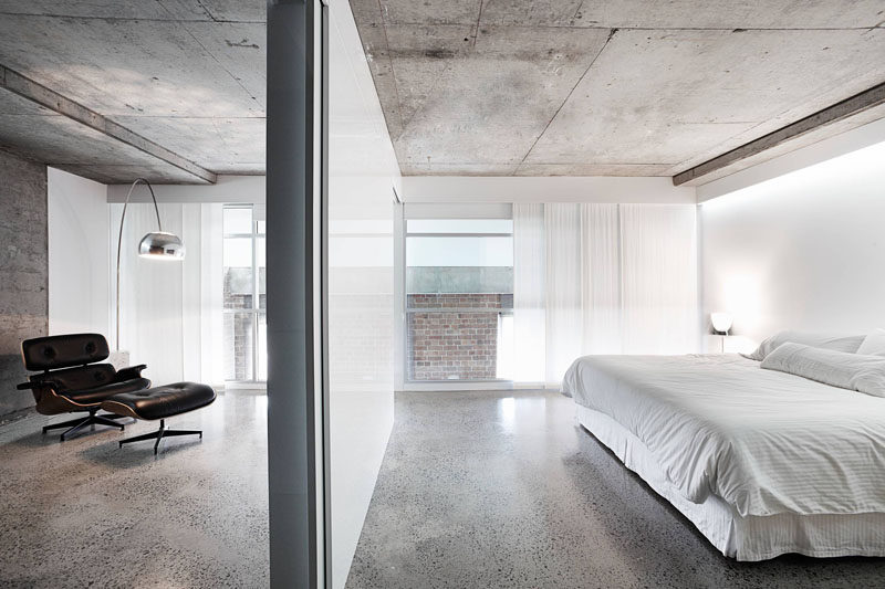 23 Pictures That Show How Concrete Floors Have been Used Throughout Homes // Polished concrete floors in the bedroom create a clean, industrial feel that gets softened and warmed with the addition of bedroom textiles like duvets, pillows, rugs, and drapery. 