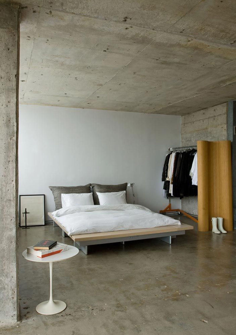 23 Pictures That Show How Concrete Floors Have been Used Throughout Homes // Polished concrete floors in the bedroom create a clean, industrial feel that gets softened and warmed with the addition of bedroom textiles like duvets, pillows, rugs, and drapery. 