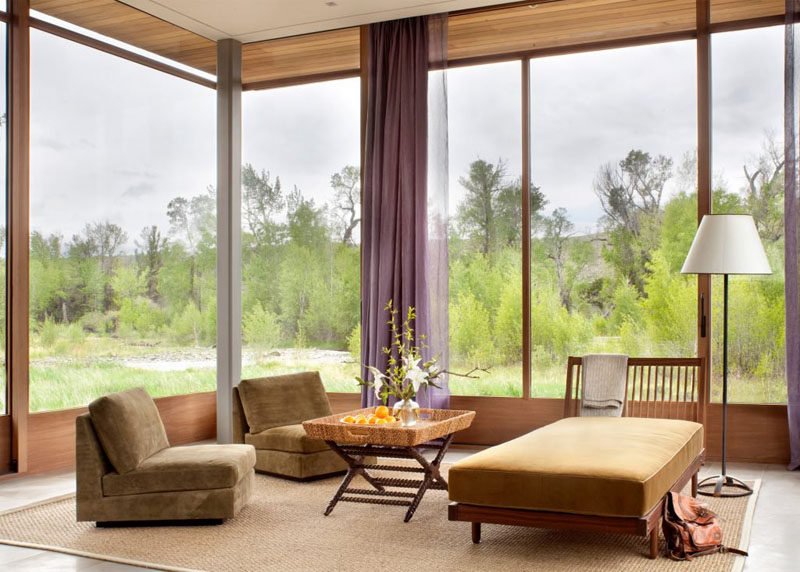 This sitting area with a day bed and a couple of lounge chairs, has large windows for taking in the view.