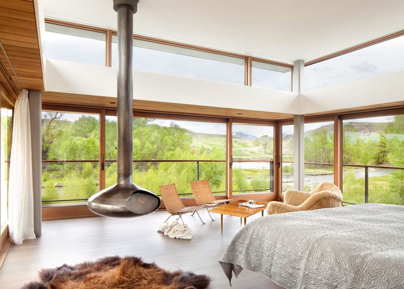 This bedroom has windows on three sides, and access to a small balcony with views of the river. A fireplace makes sure it never gets too cold in the winter.