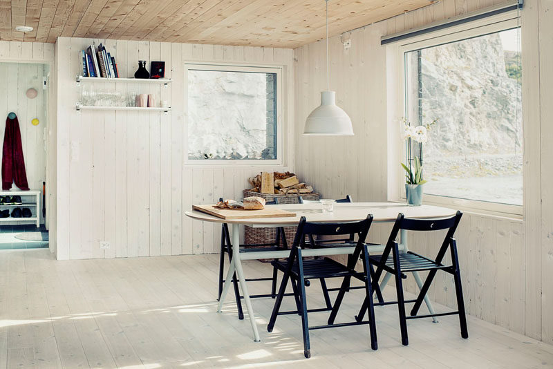 This dining area has it's own window, and a pendant light anchors the dining table in the open floor plan.