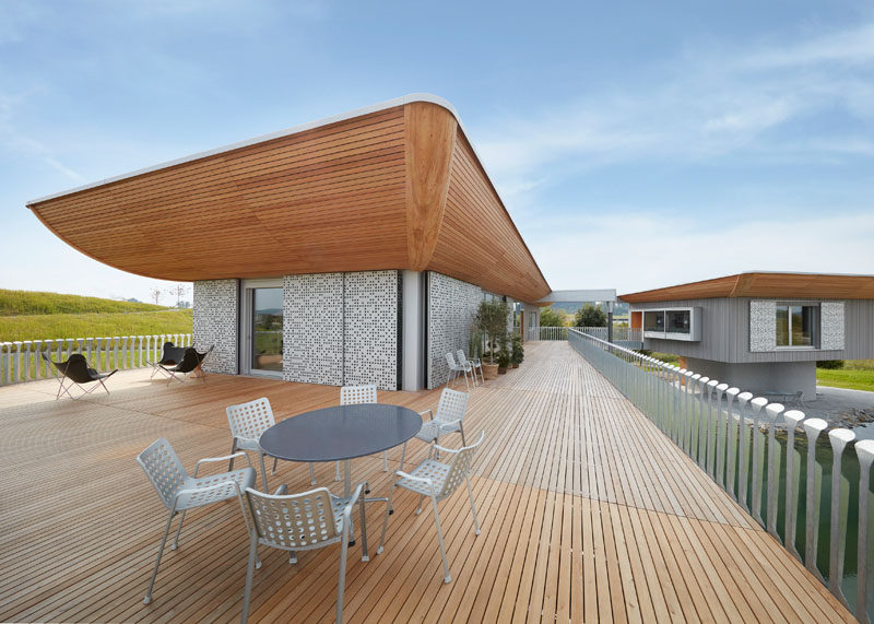 This wooden terrace wraps around the main building of this house and provides access via a bridge to the small neighboring guesthouse.