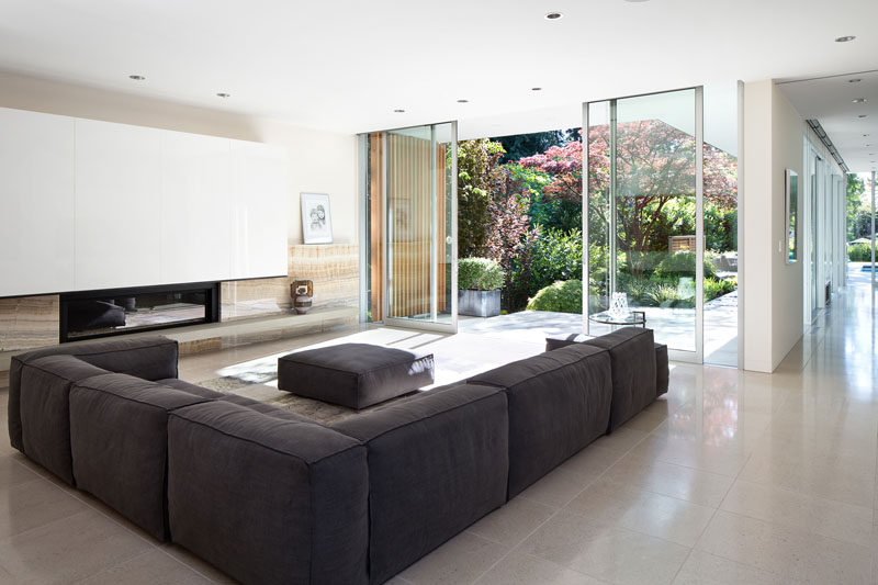 Large floor-to-ceiling sliding glass doors open up this living room to the garden outside.